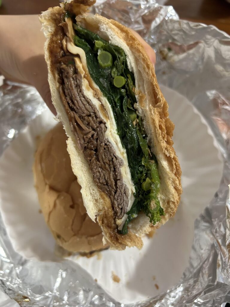 A delicious roast beef sandwich with fresh mozzarella and broccoli rabe in Brooklyn.