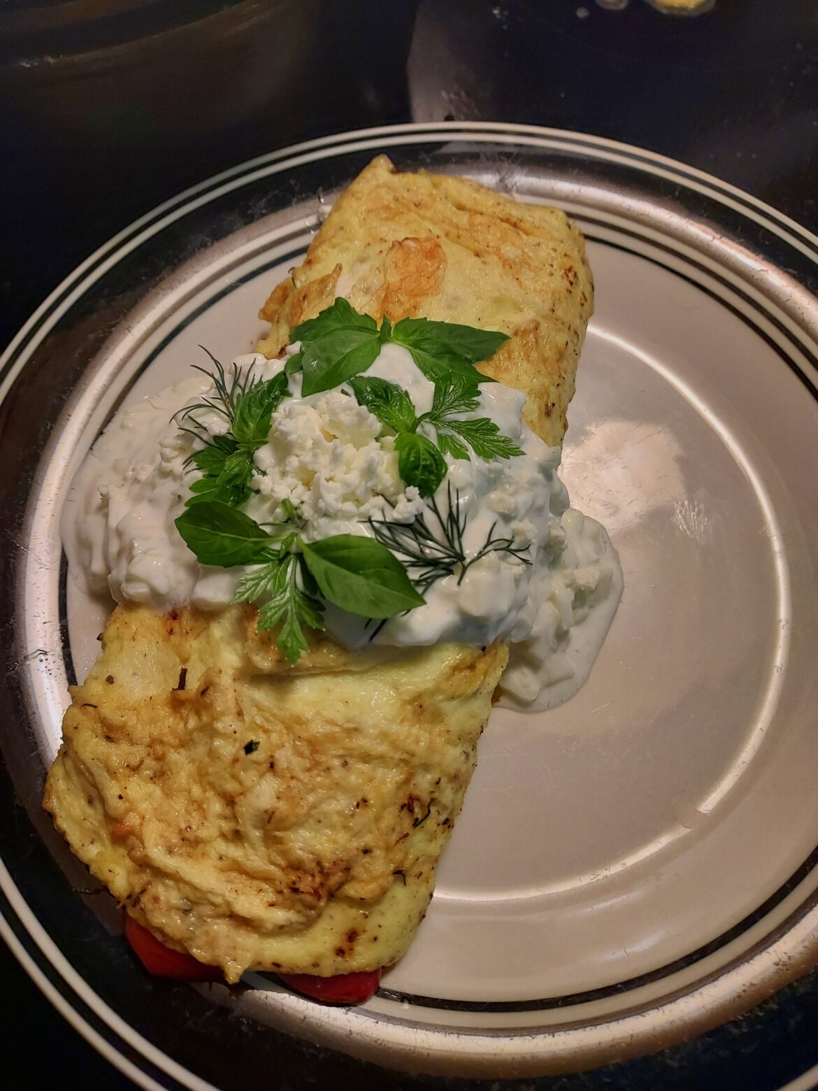 French Omelete with herbs/smoked salmon/asparagus/cherry toms/r. onion/capers. Topped with cucumber/lemon yogurt sauce & feta.
