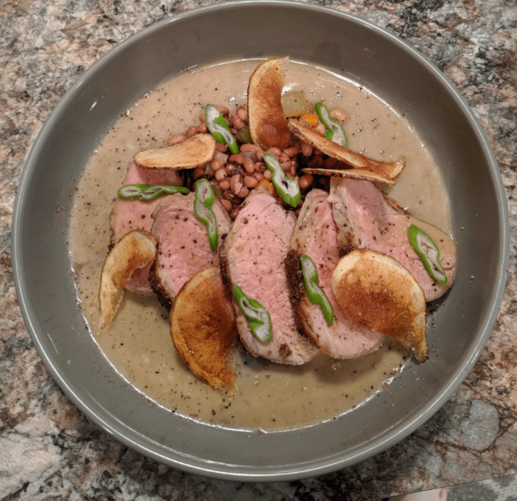Sous Vide pork tenderloin, Red Island sea peas, sea peas gravy, homemade salt and vin chip