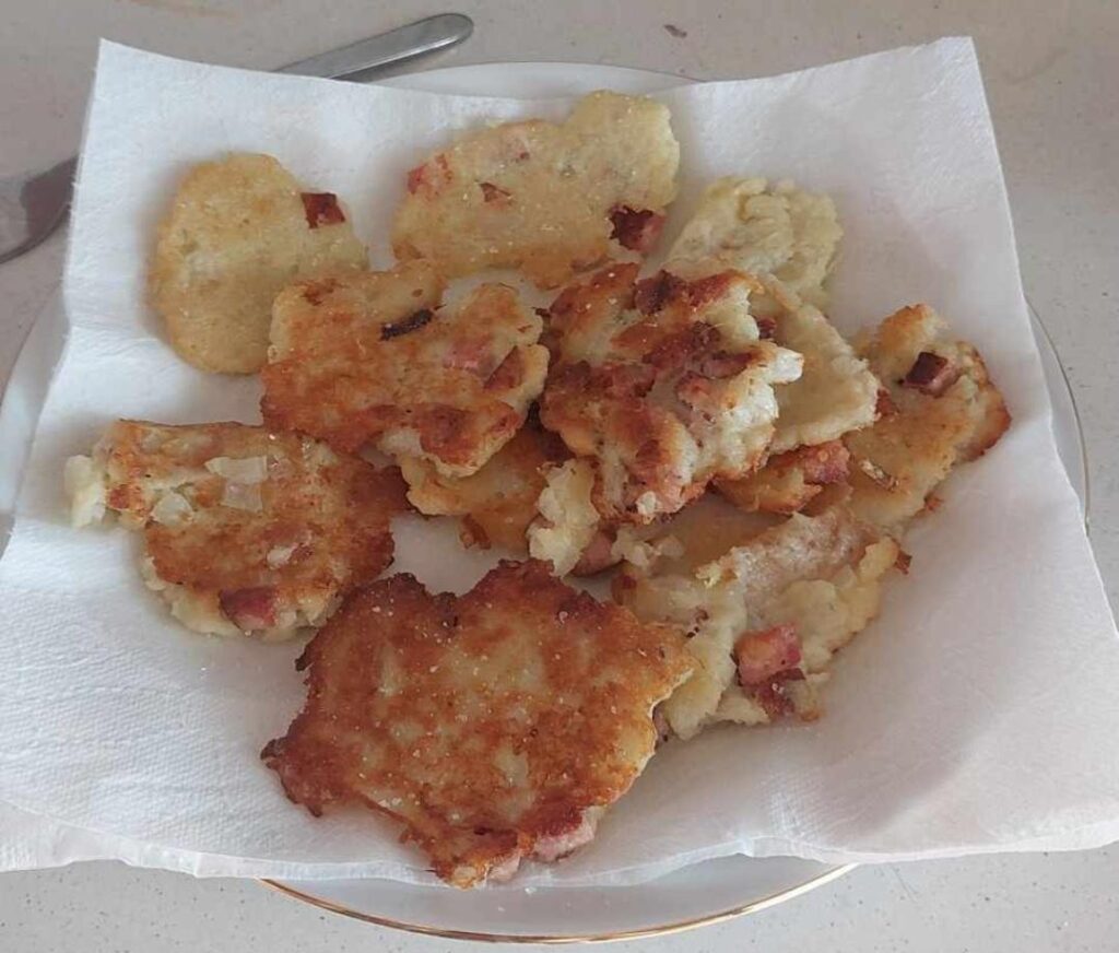 Potato pancakes with sausage and onion