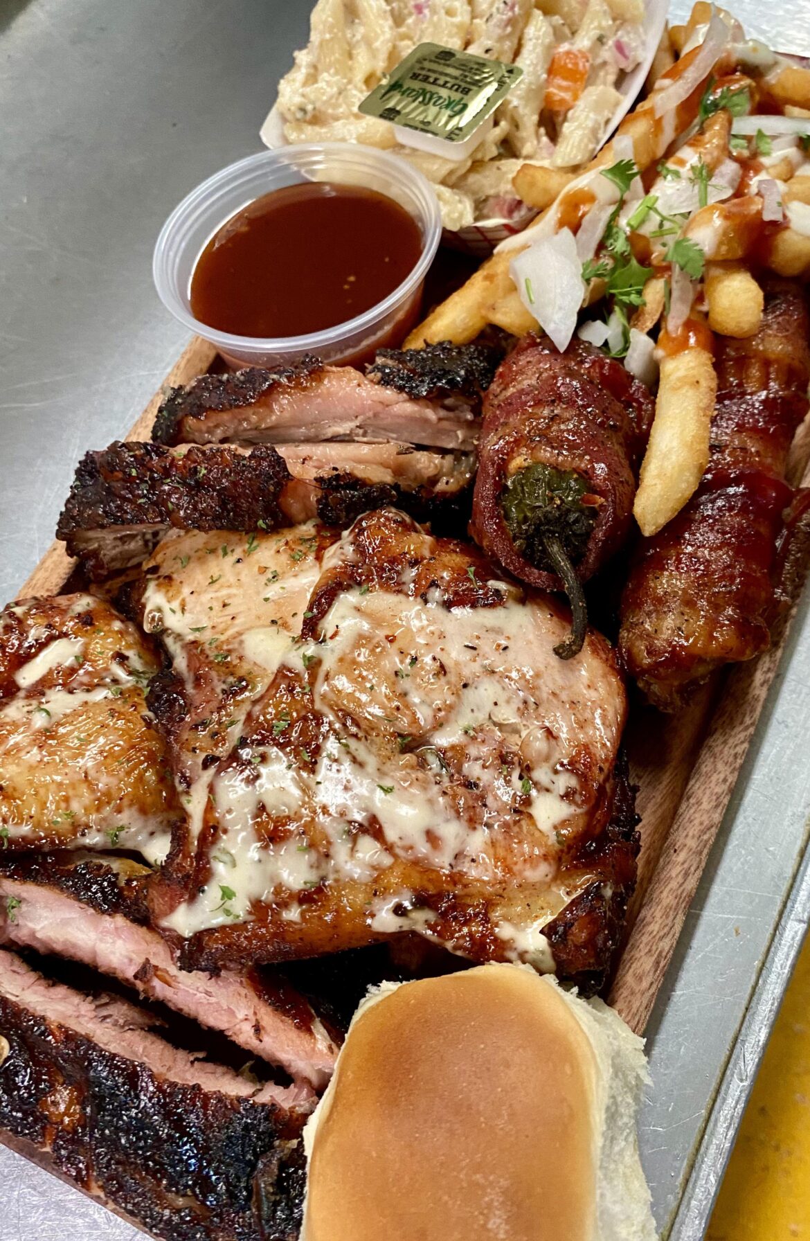 Hickory smoked brisket, no-wrap backs, chicken with Alabama white, shotgun shells with cheese, beef, chorizo, and sausage, a popper, loaded fries and some pasta.