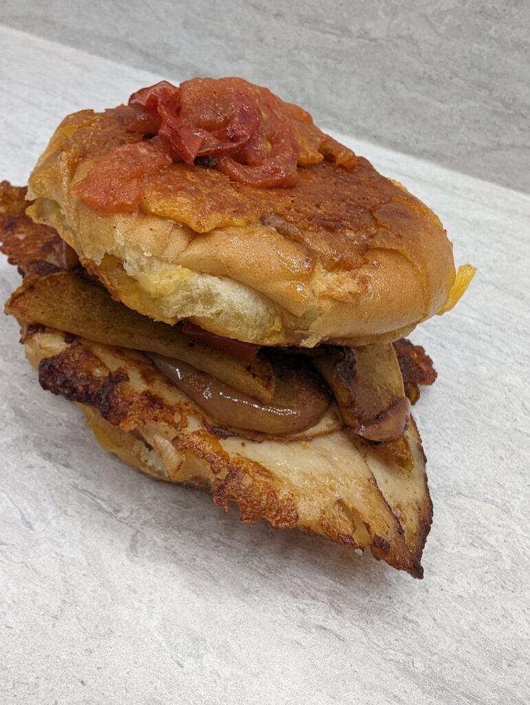 Low grocery level resulted in grilled burger bun, with baked chicken, Gouda, and fried apples and tomato. Really could've used onion.
