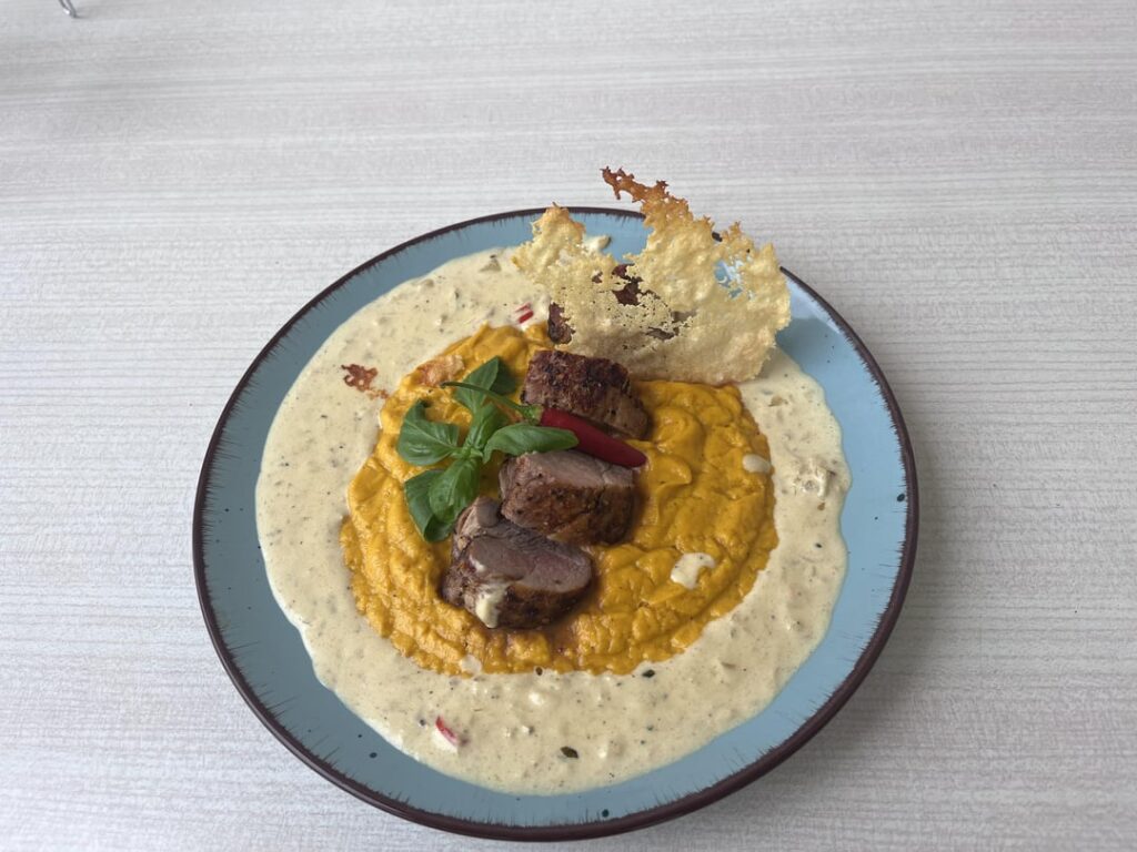 Pork tenderloin with sweet potatoes purée, mushroom basil and chilli champions sauce