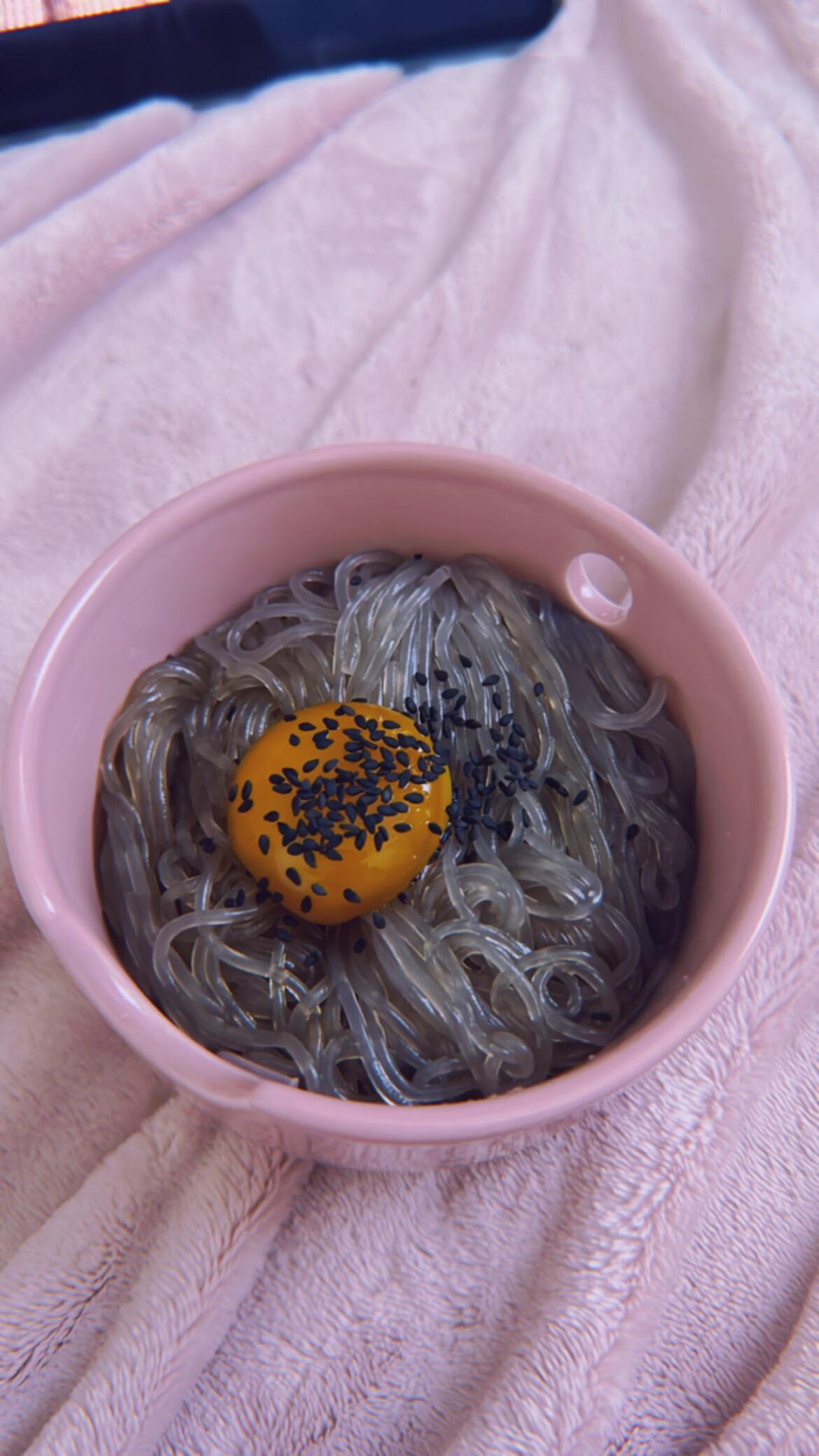 Glass noodles basically japchae without veggies with a marinated egg yolk