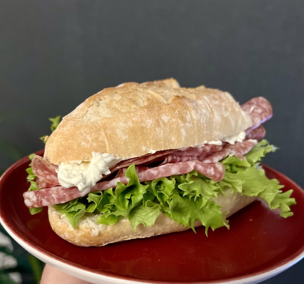 Garlic and herb cream cheese, salami, lettuce, on sourdough baguette.