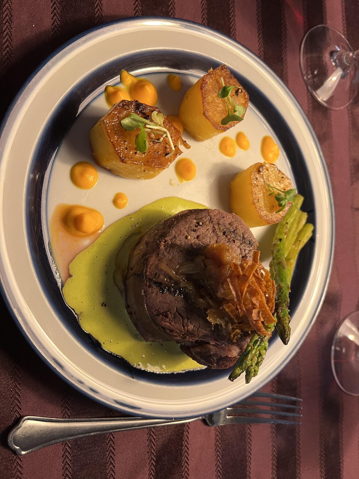 Filet, béarnaise sauce, caramelized onions, lard fried carrot skins, fondant potatoes, lemon carrot purée, grilled asparagus