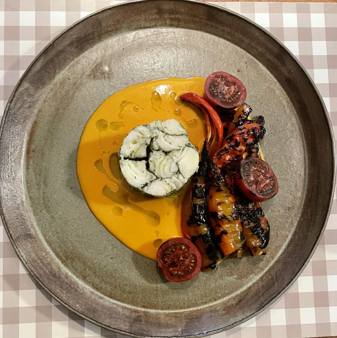 Chilean sea bass mosaic, sungold saffron sauce, charred peppers, charred tomato, basil oil