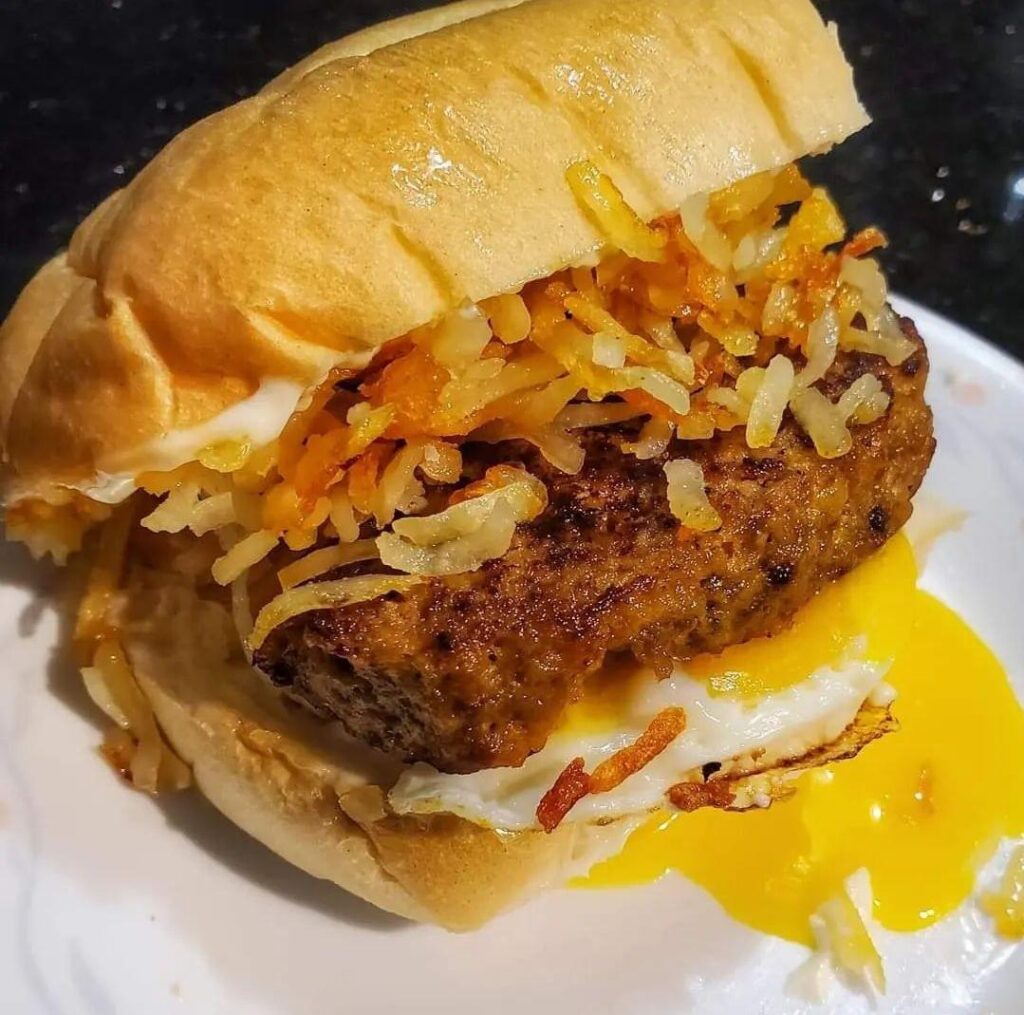 Potato hash browns, meatloaf, and a fried egg sandwich.