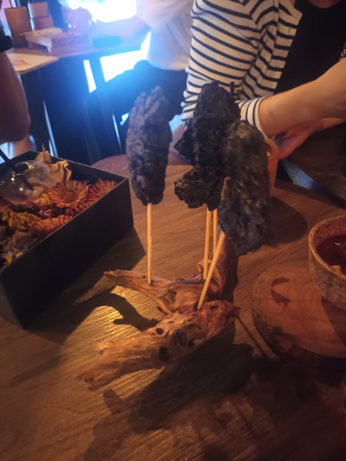 Black skin fried chicken served on driftwood
