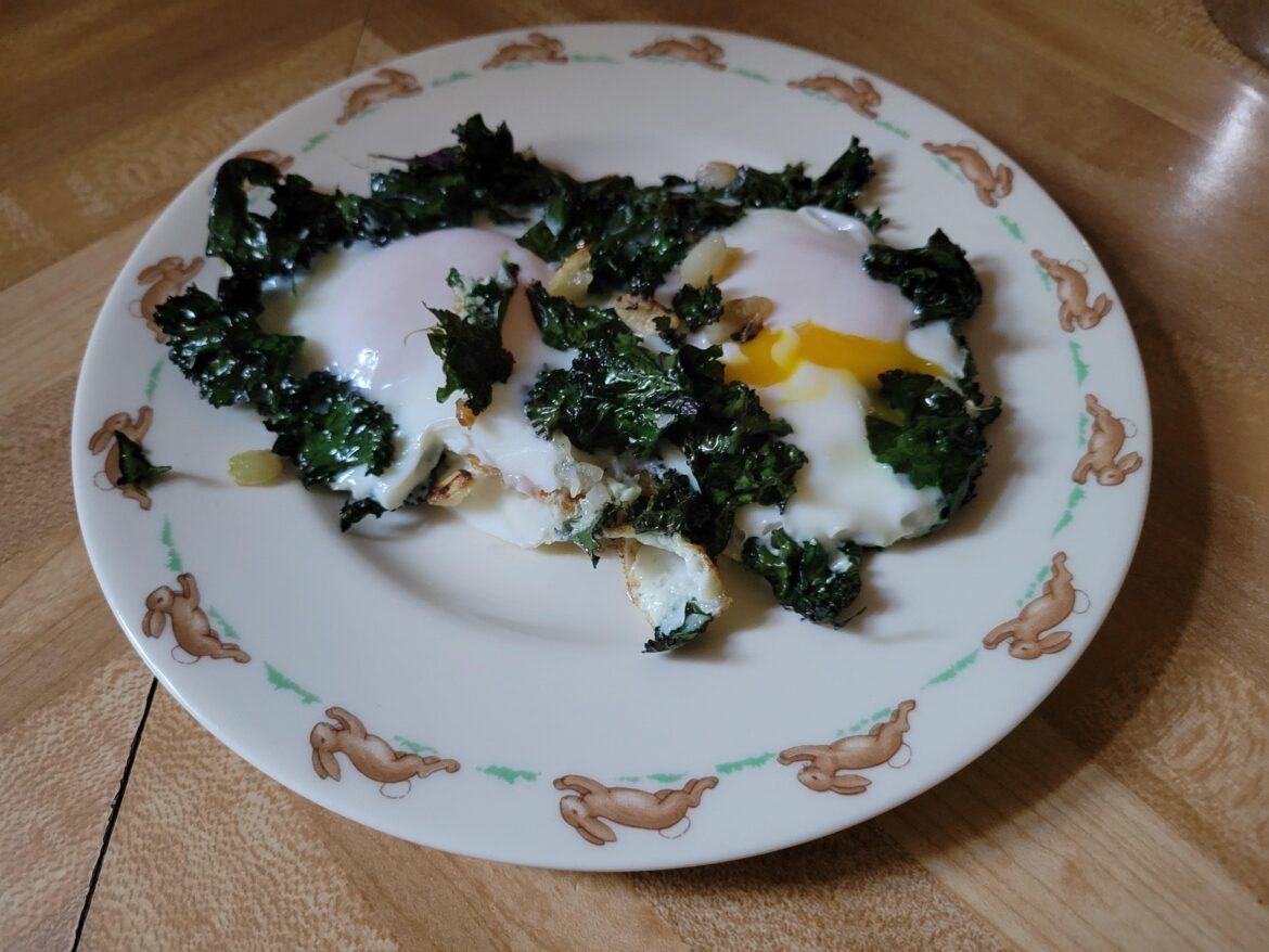 Two runny eggs🥚on a bed of sauteed homegrown kale 🥬