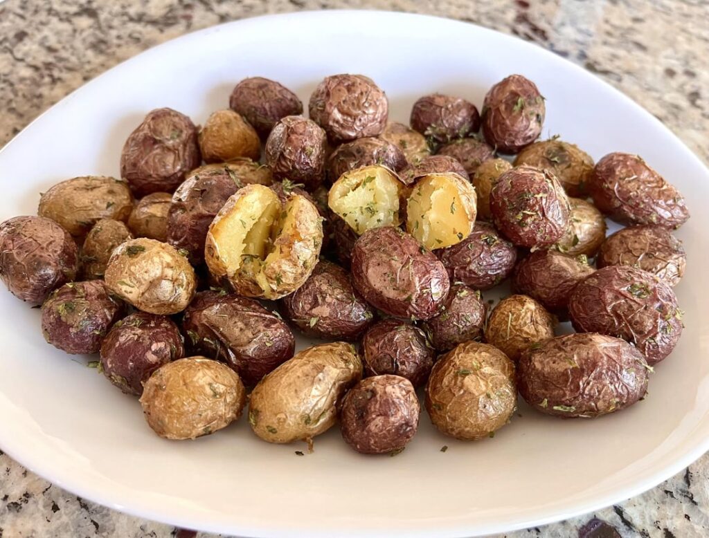 Pan-roasted skin-on peewee potatoes with garlic and dried herbs.