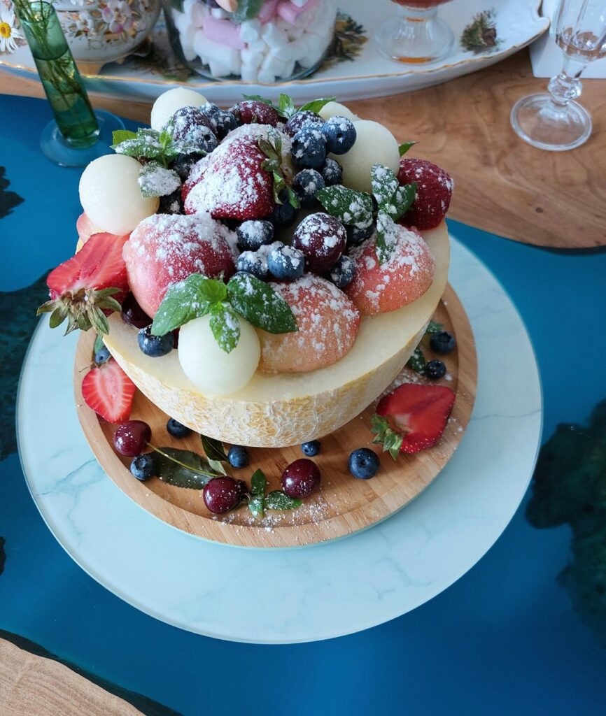A dessert of melon, strawberries, mint-and a little powdered sugar