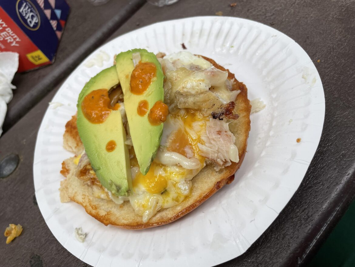 open face smoked trout and runny egg with avocado and habanero sauce on bagel