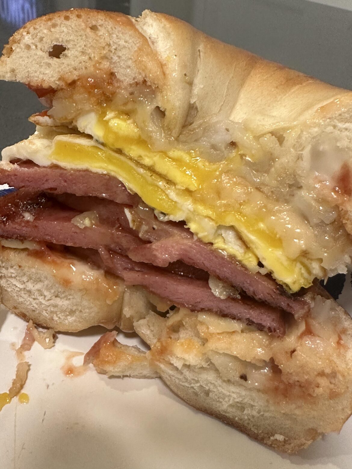 Pork roll, egg, steakhouse onion cheddar and a hash brown on a bagel with SPK and garlic aioli