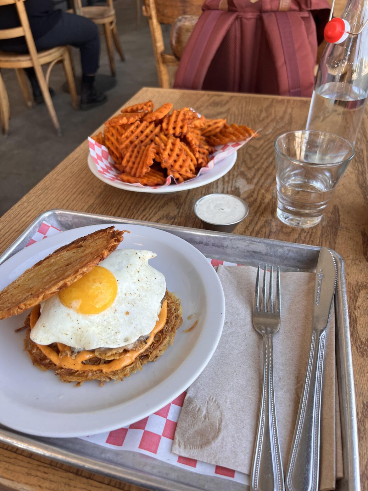 Breakfast burger with a side of sweet potato waffle fries from Cassell’s in Koreatown