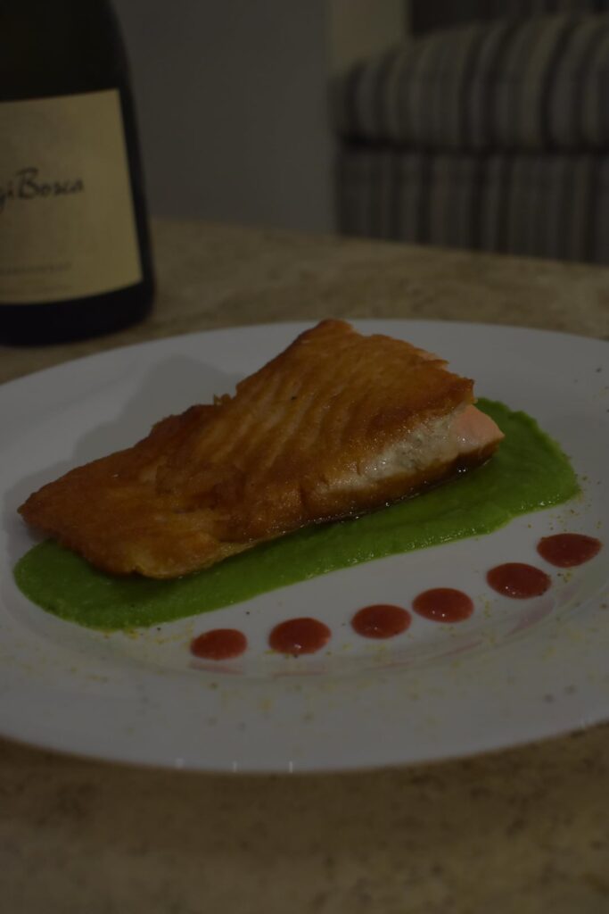 Starting to plate my dishes ( salmon on pea puré with mint and Raspberry sauce. 2° slide is a with chocolate namelaka with a rasberry interior on a chocolate crumble
