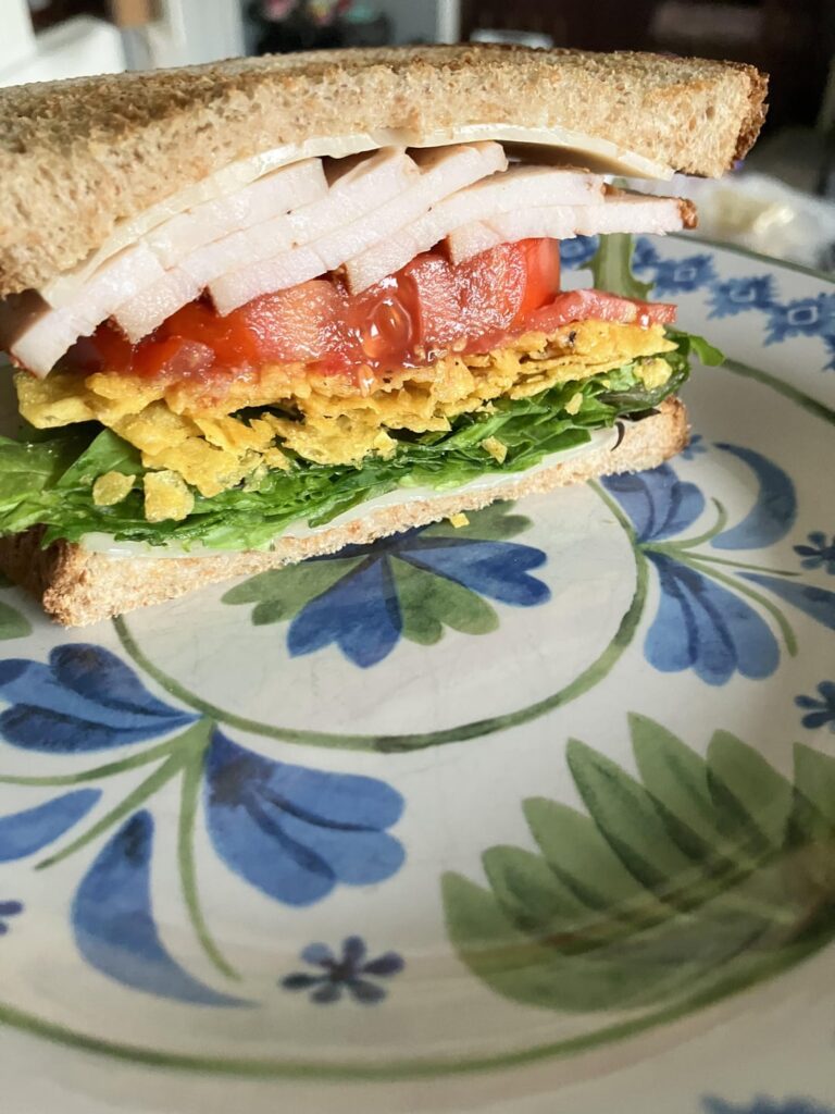 Home smoked Cajun turkey breast, homegrown tomatoes, Swiss, mixed greens (only lettuce I had), mustard Doritos, horseradish mayo