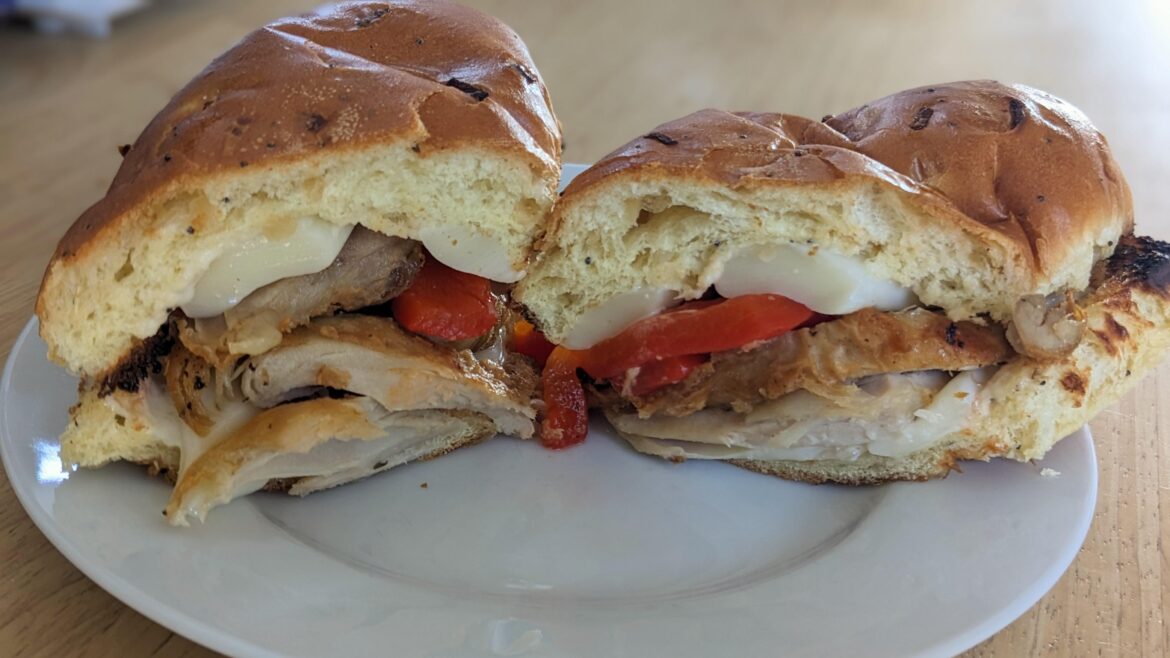 Today's depression sandwich: fried chicken thigh, melted mozz, roasted red pepper, and ranch dressing on a toasted onion roll