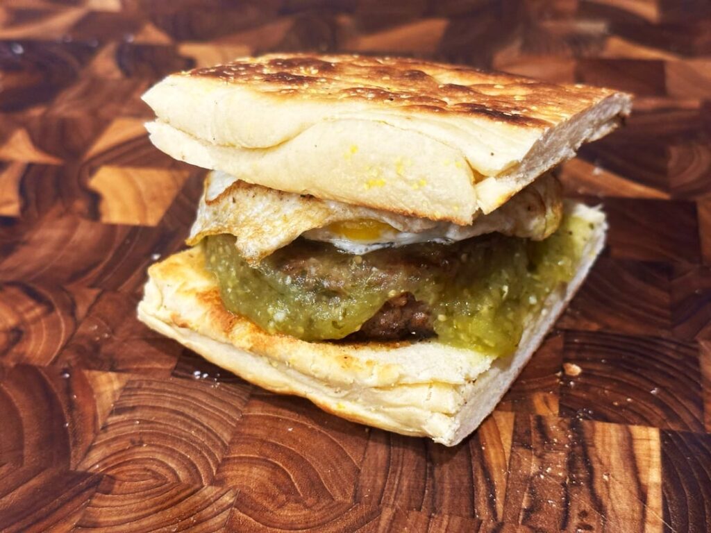 its...something: hot jimmy dean patty on a screwed up homemade english muffin and a fried egg. homemade salsa verde cuz i have a bunch and don't know what to do with it.