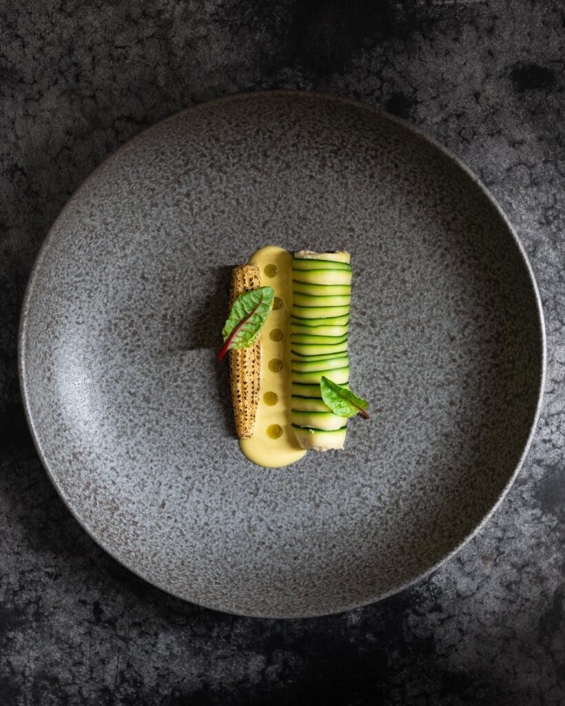 Courgette roll, corn & saffron sauce, spruce tip oil, baby corn.