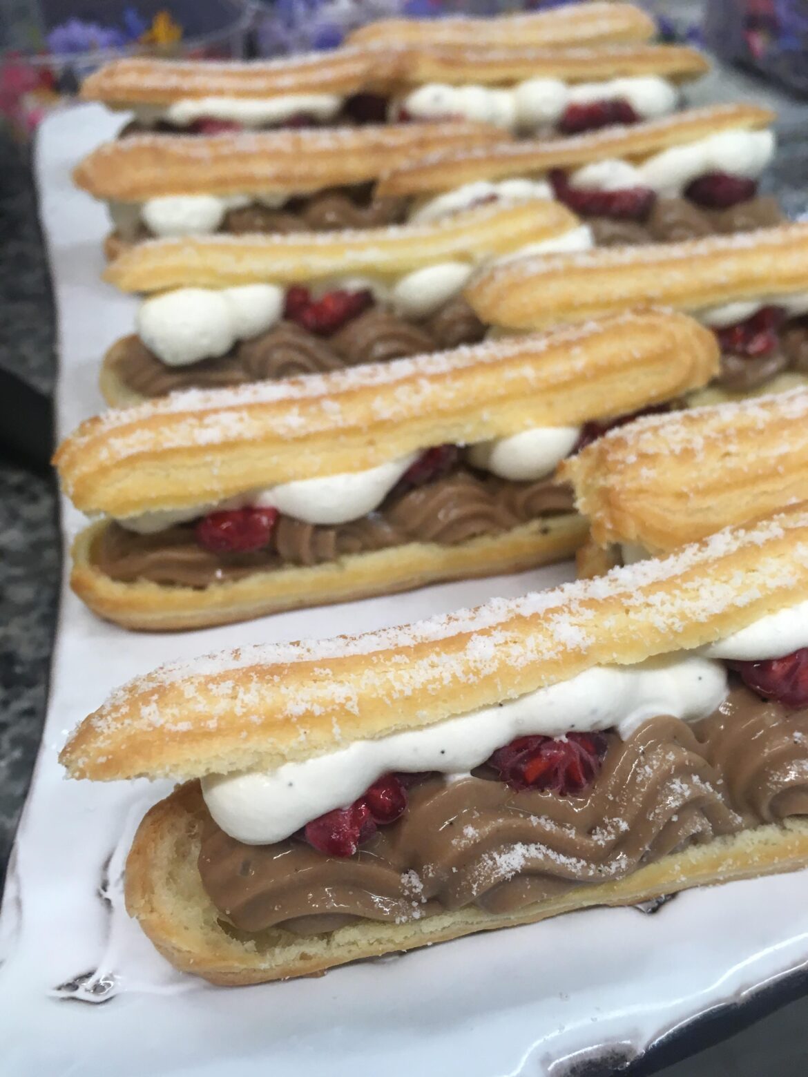 Chocolate namelaka, vanilla whipped cream and raspberry eclairs