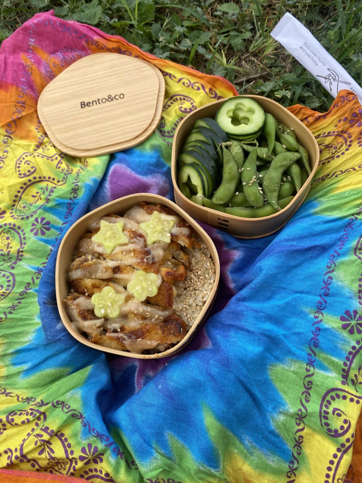 Chicken thigh on top of brown rice, cucumber and edemame