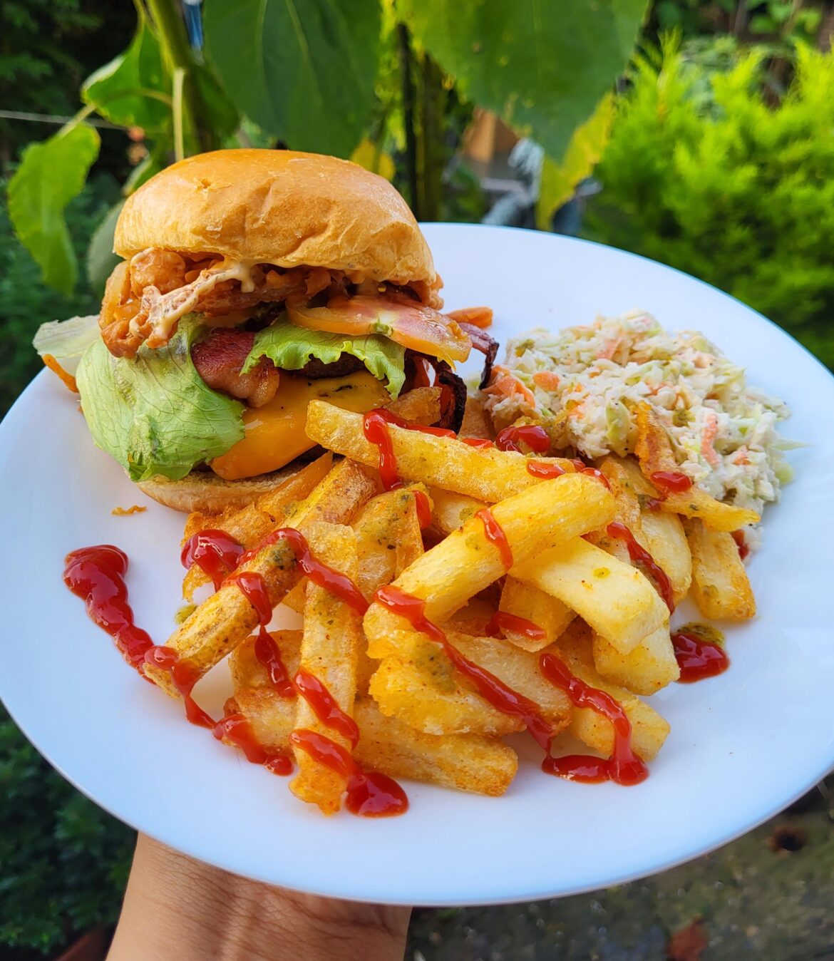 Homemade double fried chips, coleslaw and burger with crispy onions and bacon
