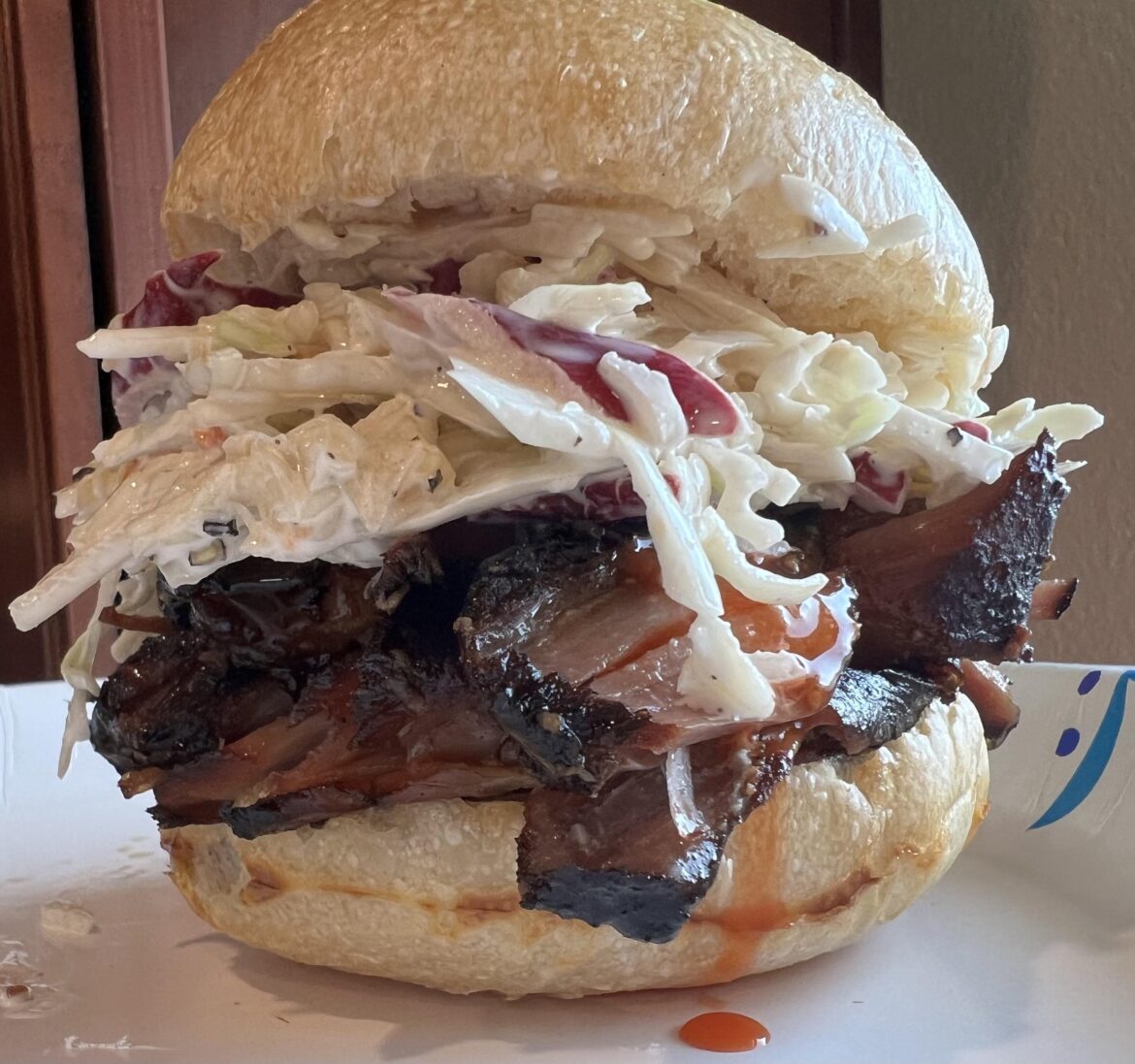 Country-style pork ribs, coleslaw, and Texas Pete on homemade roll.