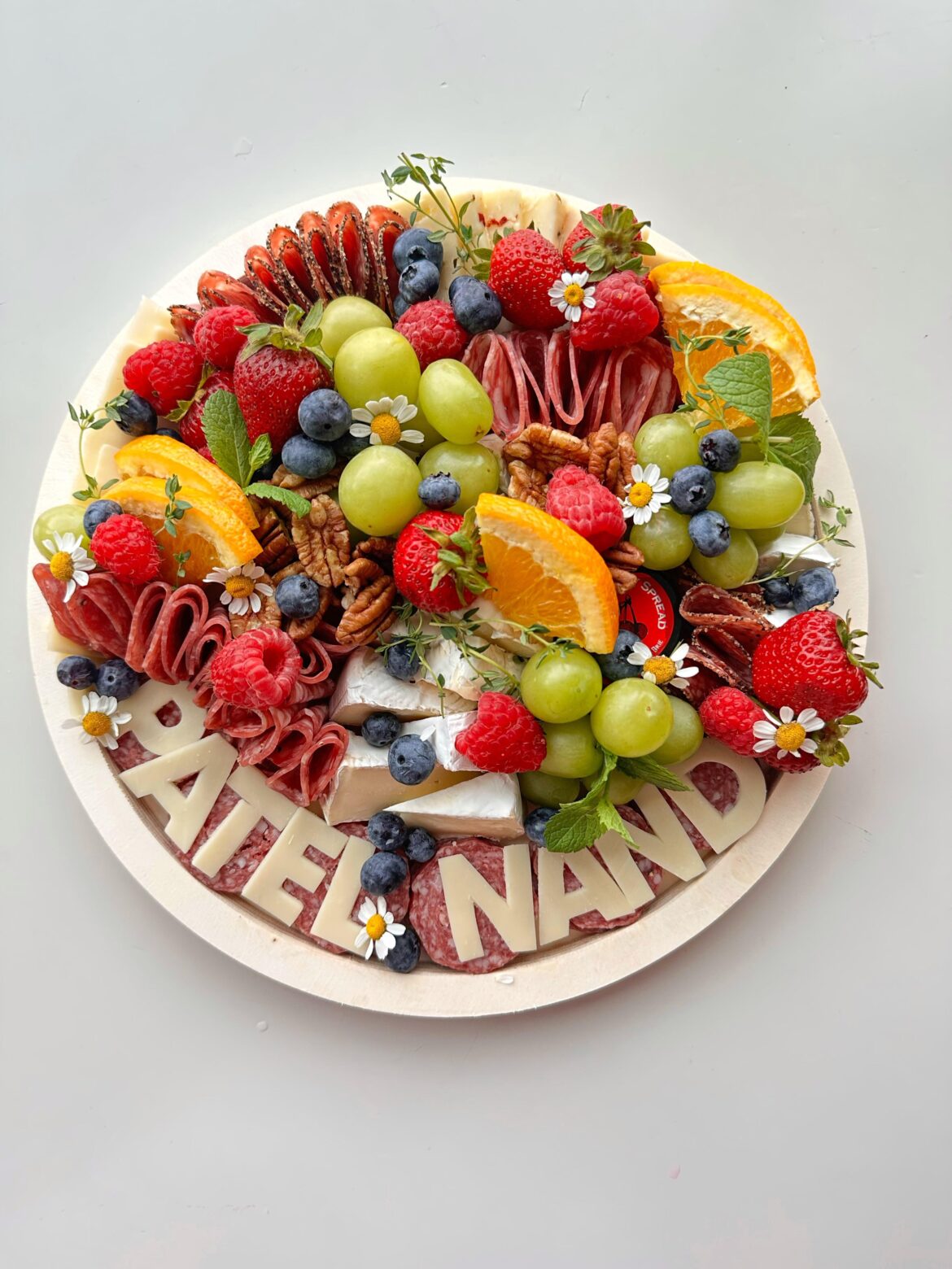 A custom meat cheese fruit board