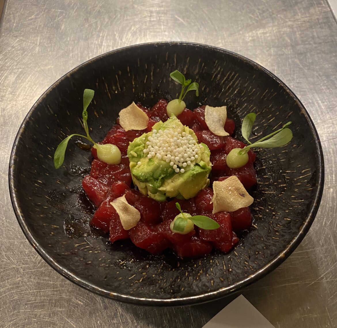 Bluefin tuna tossed in black garlic sauce, wasabi yuzu gel, fried garlic chips, avocado, and micro cilantro