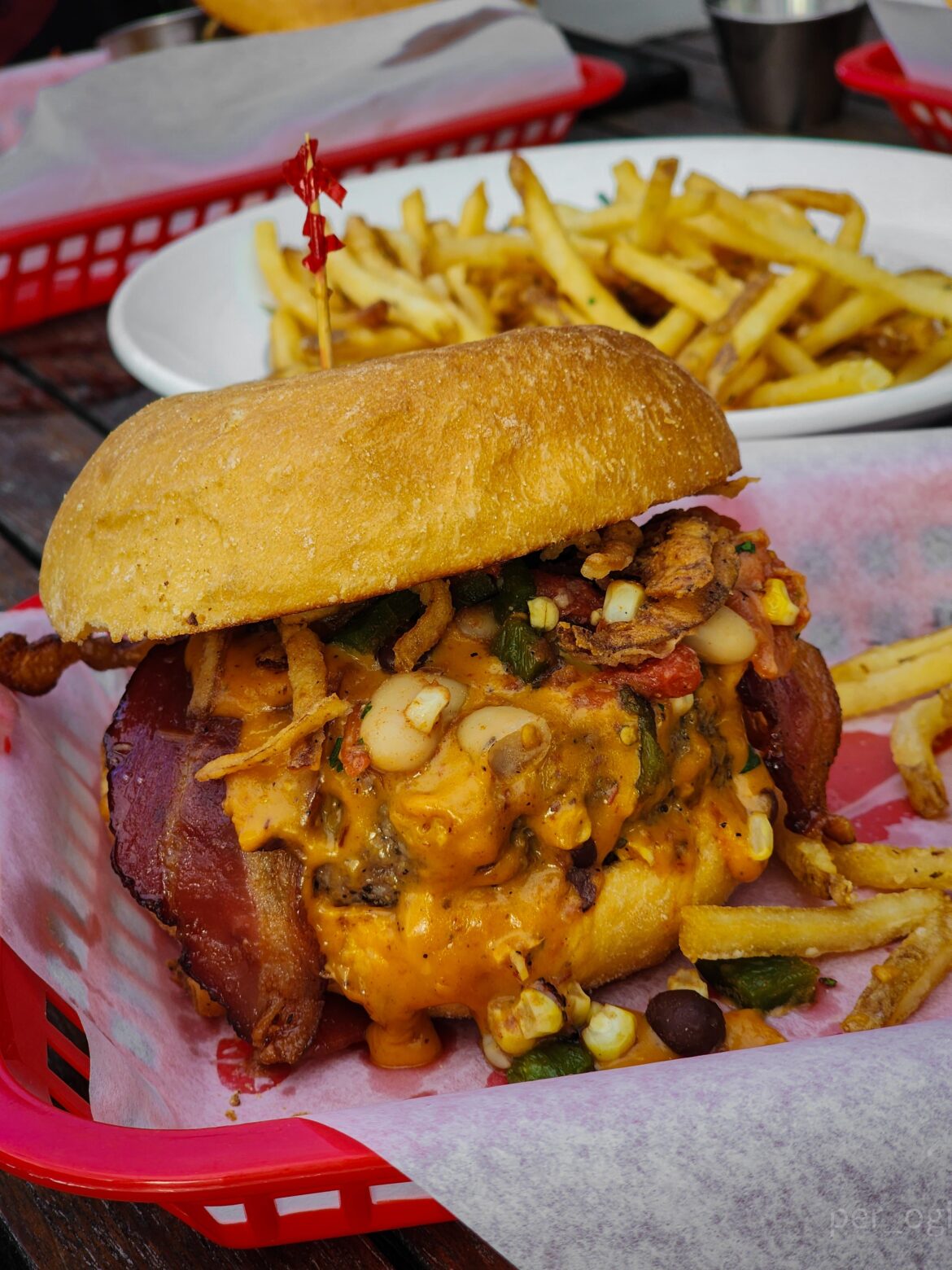 Burger w/ chipotle cheese sauce, roasted poblano salsa, bacon, and crispy onions