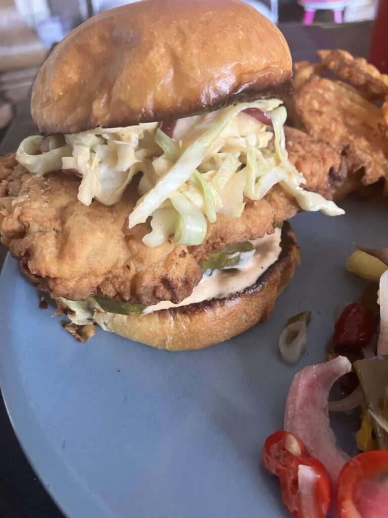 Cast iron fried chicken sandwiches. Buttermilk/hot sauce/pickle juice marinated thighs and buttermilk/pickle juice breasts. Honey mustard slaw, bean salad, waffle fries.