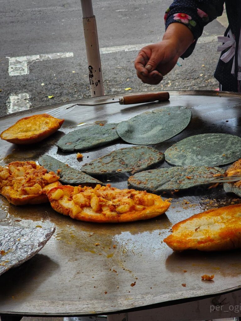 Pambazo - bread dipped, and fried in red guajillo pepper sauce, and filled with potatoes and chorizo