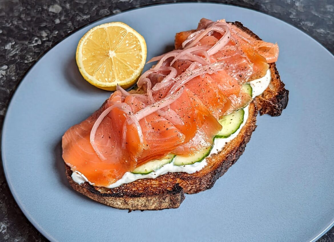 Smoked salmon, sour cream, pickled cucumber and shallots on sourdough