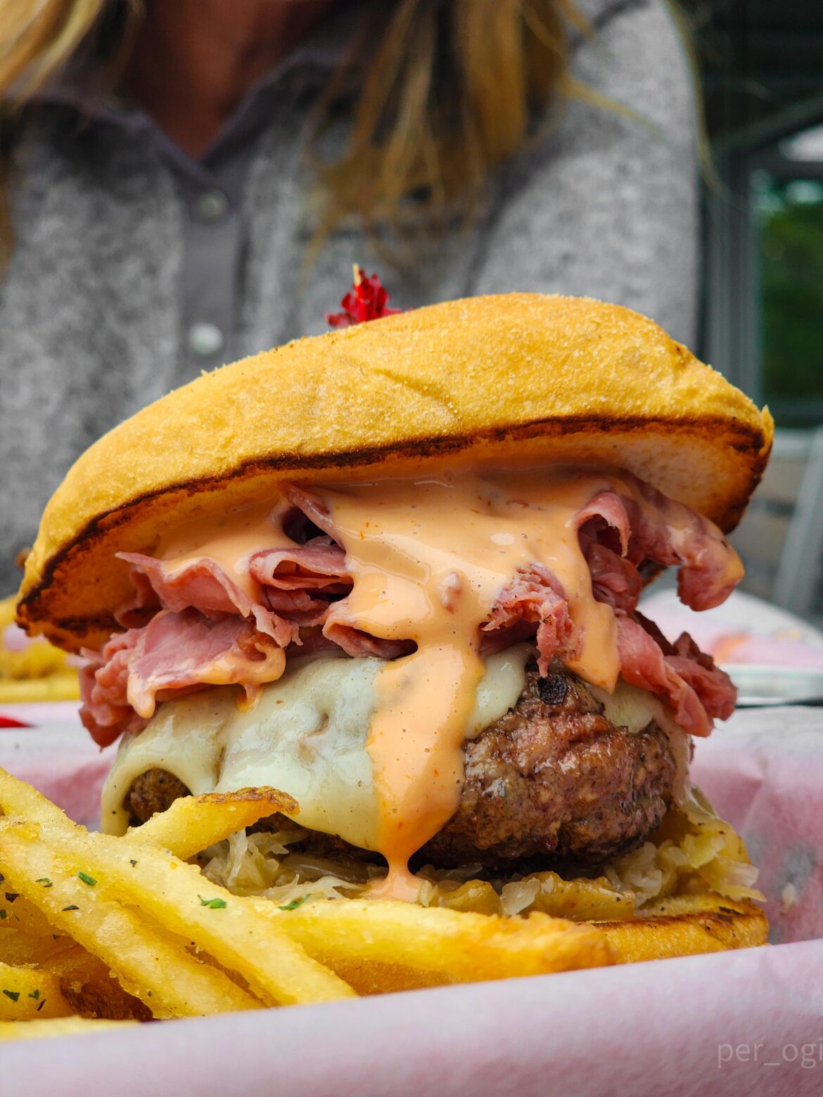 Burger w/ corned beef, swiss, caramelized onions, thousand island, sauerkraut