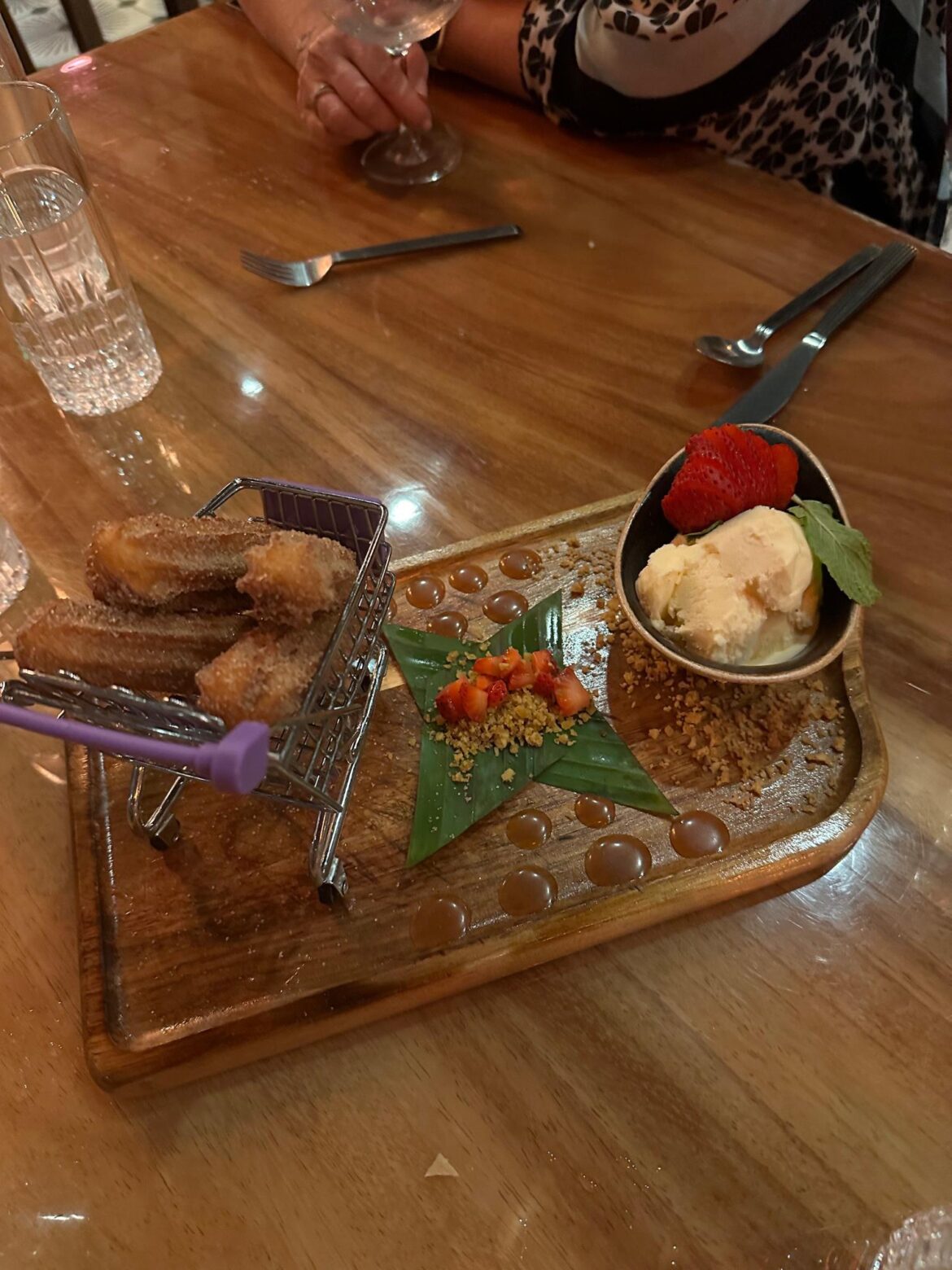 Churros in a shopping cart, caramel on a board, ice cream in a? plates, not a one.