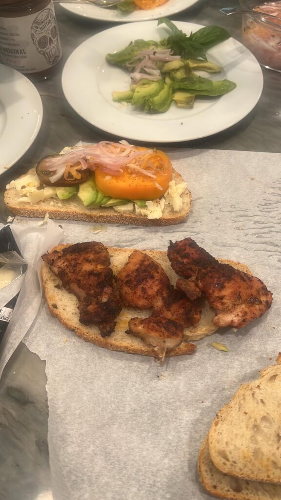 Grilled chicken sandwich with dressed heirloom tomato, sartori montamore, avocado, and pickled shallots and habanero