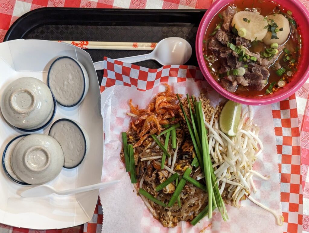 Pad Thai, bowl of beef soup, and steamed coconut pandan dessert at Lad Nah Silom