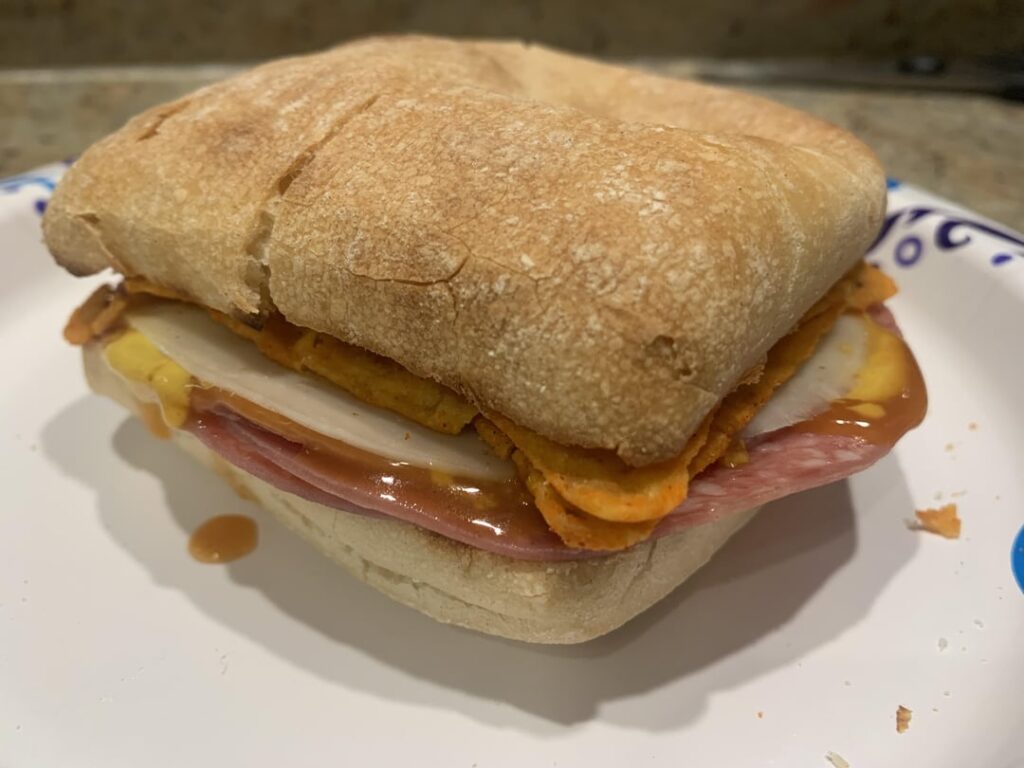 Taking it back to basics with a salami, provolone, Doritos, mustard and hot sauce