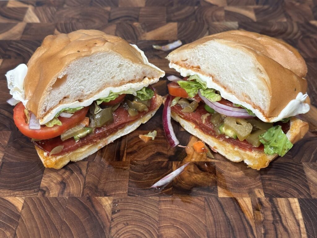 pepperoni and fresh mozz w/tomato, lettuce, red onion, mustard, italian hot sauce, sub dressing and giardiniera pepperoni and fresh mozz w/tomato, lettuce, red onion, mustard, italian hot sauce, sub dressing and giardiniera