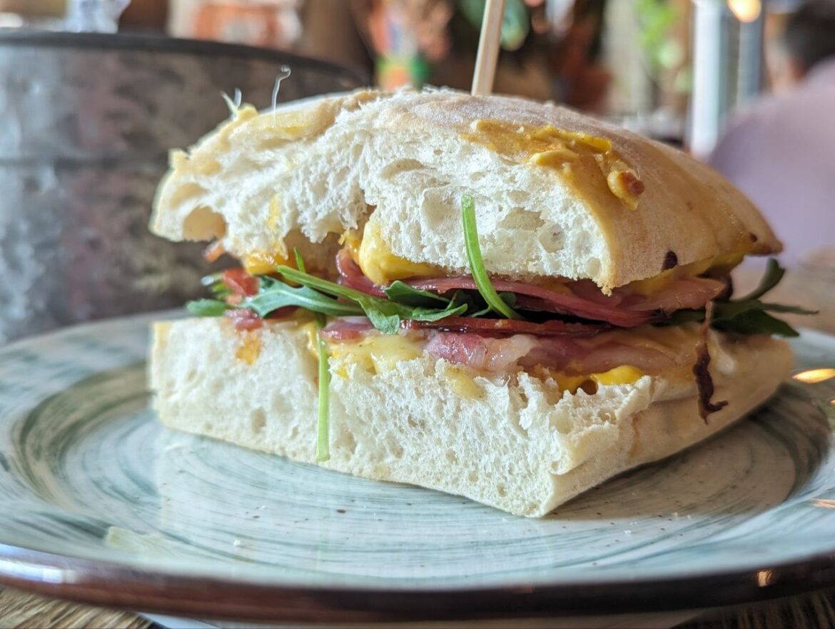 Sandwich with bacon and chorizo, tasty meat, lots of cheese, juicy, slightly spicy