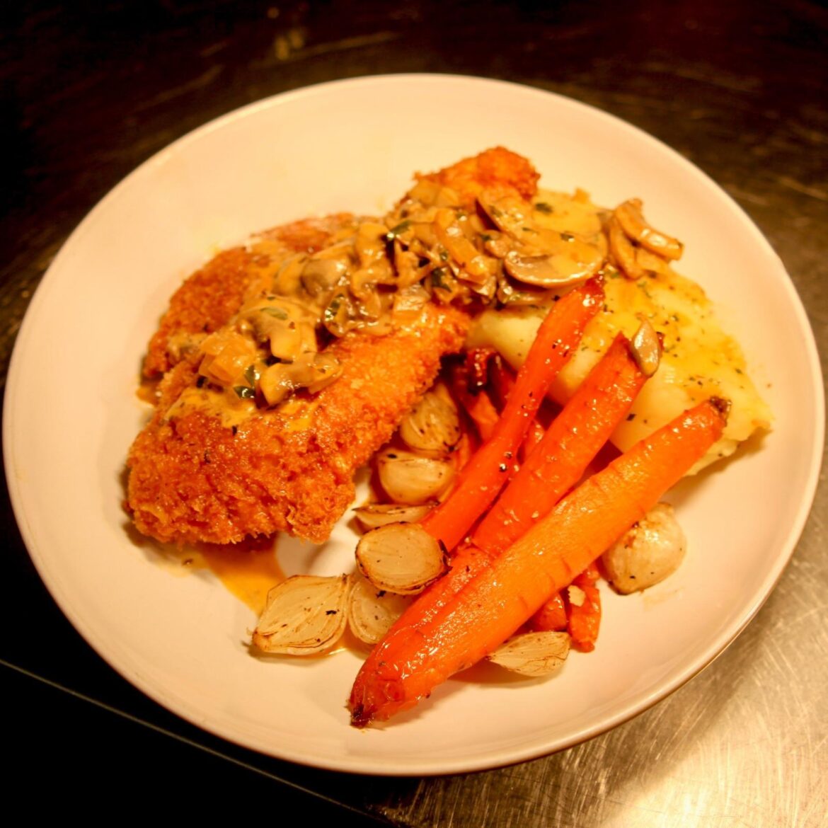 Chicken schnitzel, mustard Mashed potato, Honey roasted carrots, Picked & charred silver-skin onions, Jäger sauce