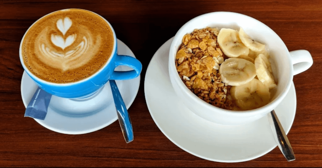 Coffee and cereal bowl with fruit