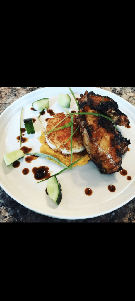 Grilled chicken thigh marinated in tamarind and fish sauce, sweet soy, crispy rice cake, sweet potato puree, and quick pickle