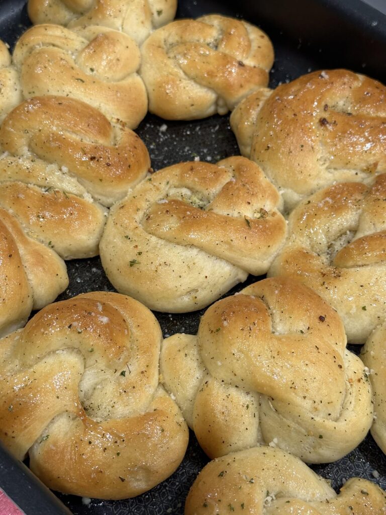 homemade garlic knots, creamy garlic chicken, and fluffy white rice