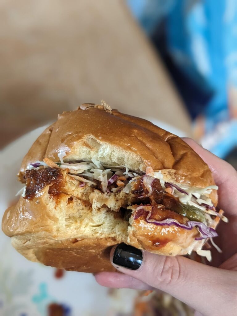 Barbeque tofu on brioche bun with pickles and coleslaw
