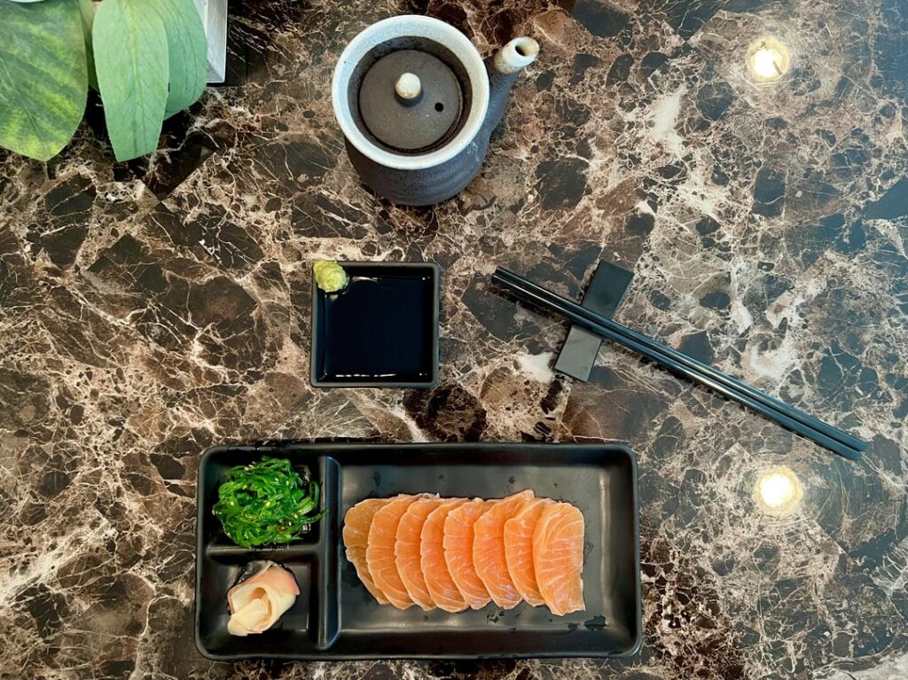 Salmon sashimi with wakame, real wasabi root, and XO soy sauce.