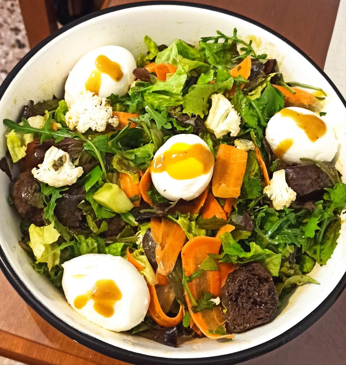 Homemade salad with boiled eggs and carob rusks.