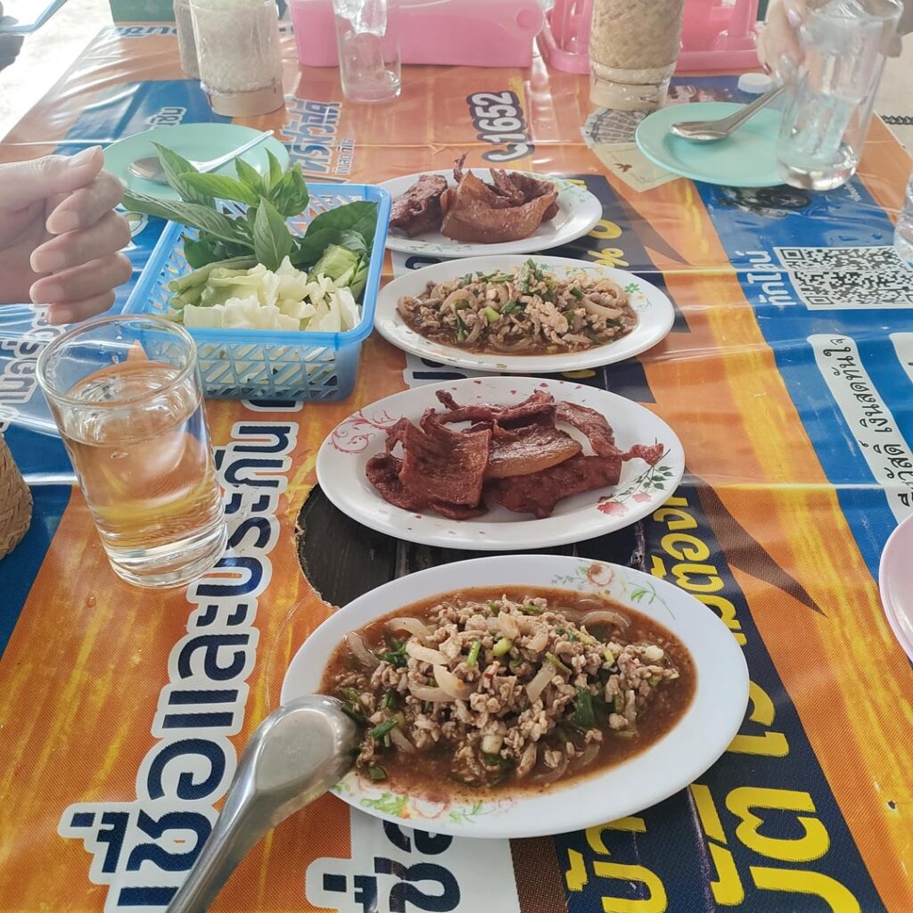 Moo pork, fried pork with vegetables and sticky rice. Literally sitting on the side of the road in chaiyaphum Thailand. Oh yeah I forgot the beer.
