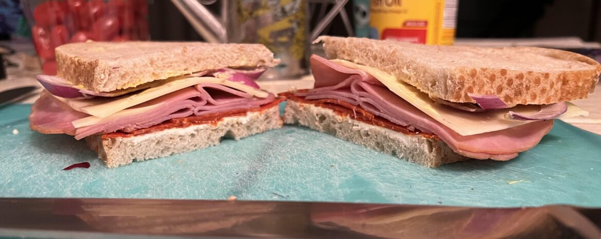 Quick one I made for work. Pepperoni, ham, Swiss, cream cheese, Japanese Mayo, mustard, and red onion on cracked wheat sourdough.
